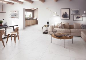Spacious modern living room with large-format ceramic floor tiles in neutral tones, creating a seamless and elegant surface.